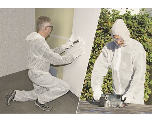 Deux artisans en combinaison de protection effectuant des travaux de rénovation