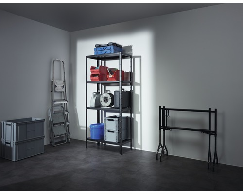 Photo d''un sous-sol avec une étagère contenant des boîtes, des boîtes à outils, un enrouleur de câble et un seau, ainsi qu''une échelle, deux boîtes pliantes grises et une table à tapisser.