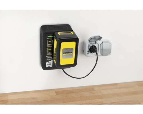 Chargeur de batterie Kärcher avec batterie monté au mur et connecté à une prise de courant avec un câble d''alimentation