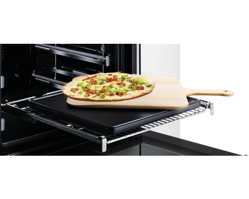 Flammkuchen auf Holzbrett im Ofen