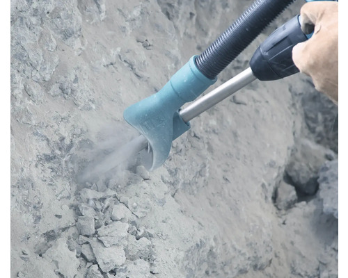 Aspiration de poussière sur un mur lors de travaux de perçage
