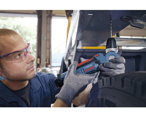 Un homme perce du métal avec une perceuse d''angle sans fil