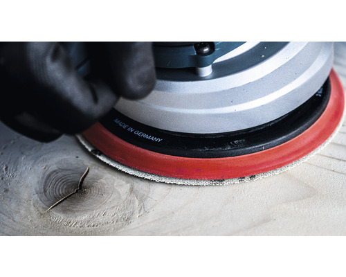 Gros plan d''une ponceuse excentrique travaillant le bois