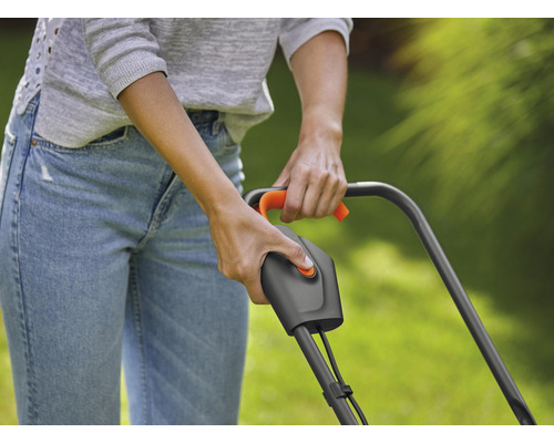 Eine Person bedient einen Rasenmäher