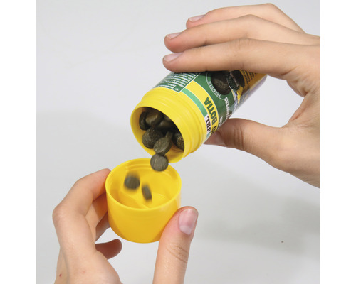 Person schüttet Fischfutter aus einer JBL Dose