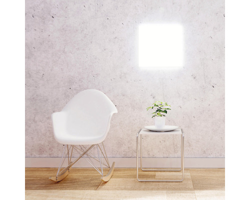 Pièce lumineuse avec applique murale carrée, fauteuil à bascule et table d''appoint avec plante