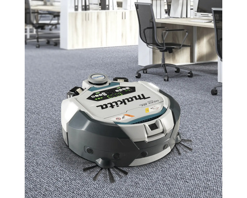 Aspirateur robot Makita en service dans un bureau.