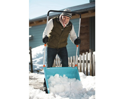 Une personne utilise une pelle à neige pour déneiger