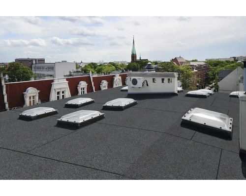 Dach mit Bitumenbahnen und Dachfenstern in einer Stadtszene