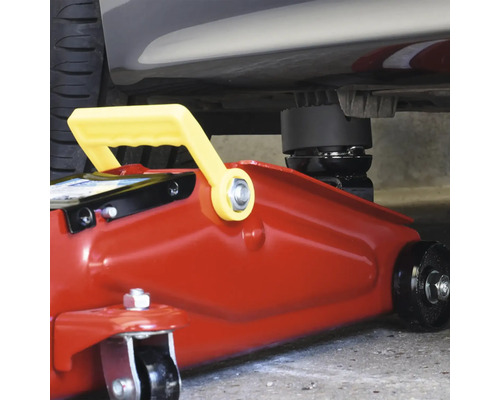 Ein roter Wagenheber hebt ein Fahrzeug an.