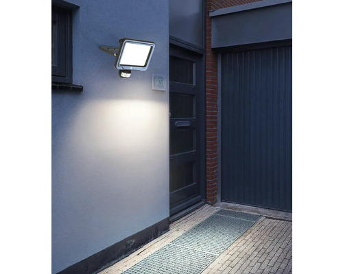 Photo extérieure d''un mur de maison avec un projecteur LED avec détecteur de mouvement monté