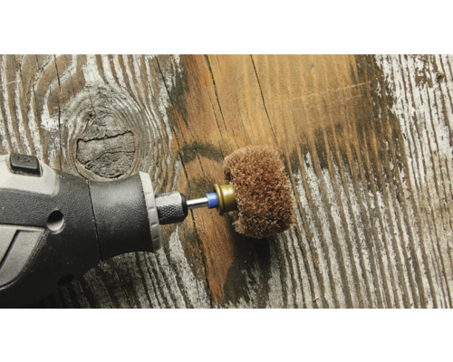 Outil rotatif avec embout de ponçage sur fond en bois