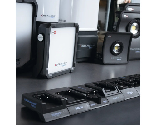 Plusieurs lampes de travail ScanGrip et un chargeur pour batteries de différentes marques telles que Bosch et DeWalt