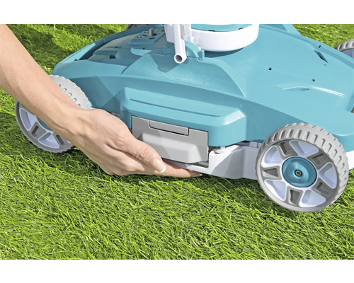 Une personne insère la batterie dans une tondeuse à gazon.