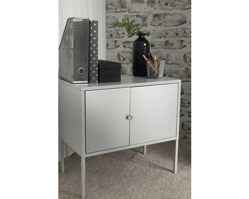 Schrank mit zwei Türen, Aktenordner, Zeitschriftensammler, Schachtel, Vase und Stiftebecher auf einer Arbeitsfläche