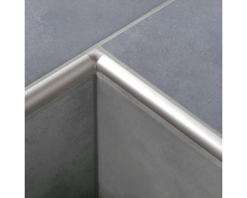 Vue détaillée d''un rail profilé en quart de cercle en aluminium monté sur des carreaux gris