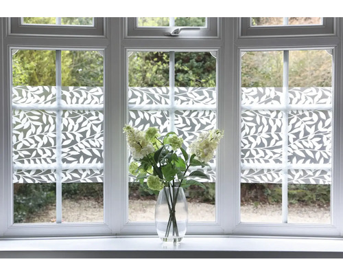 Film décoratif avec motif de feuilles sur fenêtre avec vase de fleurs