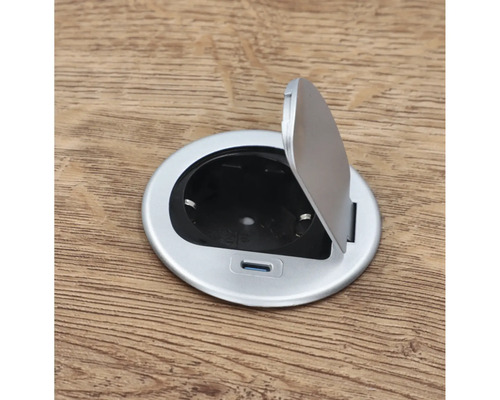 Prise de sol ronde avec couvercle ouvert sur plancher en bois