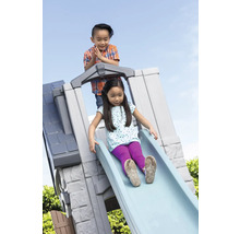 Zwei Kinder spielen auf einer Kinderrutsche im Freien.