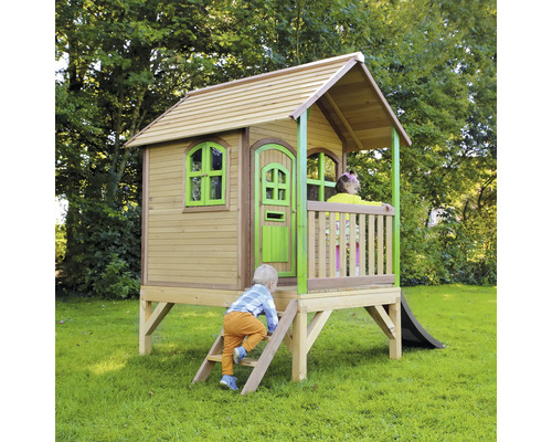 Cabane de jeux en bois avec toboggan dans le jardin avec des enfants qui jouent