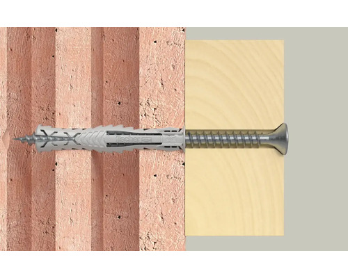 Fixation d''une cheville Fischer avec vis dans un mur en briques et une planche en bois.