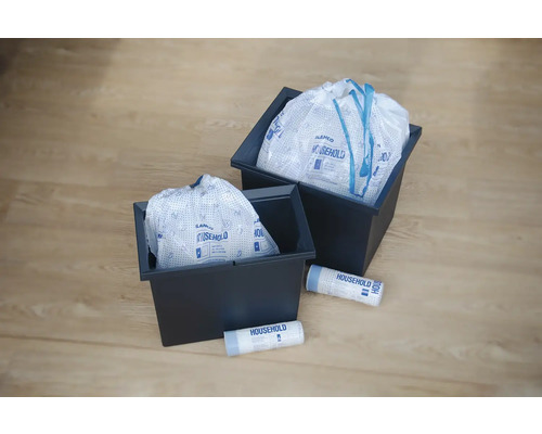 Deux récipients sombres avec des sacs à linge et deux rouleaux de sacs à linge