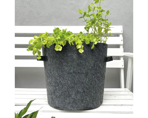 Pot de fleurs en feutre avec herbes aromatiques sur un banc