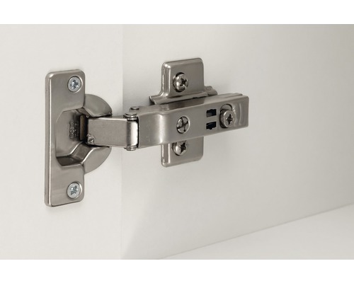 Charnière de porte de placard en métal fixée sur une porte blanche