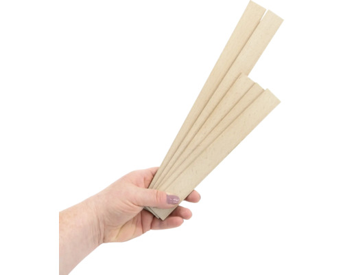 Une main tient plusieurs lattes de bois.