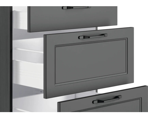 Detailaufnahme eines grauen Schubladenschranks mit offenen Schubladen.