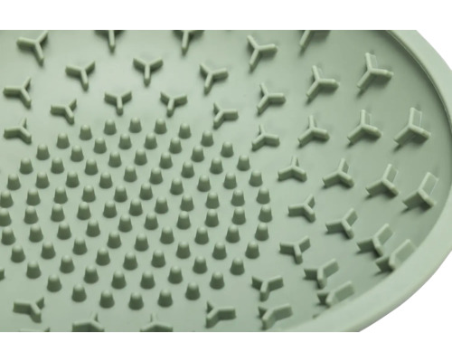 Nahaufnahme einer runden Abdeckung mit Noppen und dreieckigen Erhebungen.