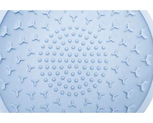 Gros plan sur un tapis de nettoyage rond en silicone avec des picots et des reliefs triangulaires.