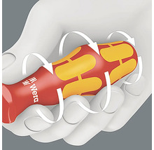 Manche de tournevis ergonomique dans la main avec des flèches indiquant le mouvement de rotation