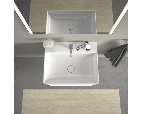 Aufnahme von oben eines Badezimmers mit Waschbecken, Seife, Handtuch und Spiegel