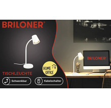 Schwenkbare, weisse Briloner Tischleuchte auf einem Schreibtisch