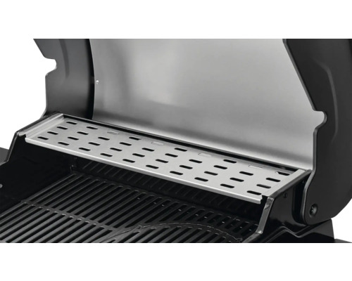 Gros plan d''une grille de barbecue avec une grille de maintien au chaud