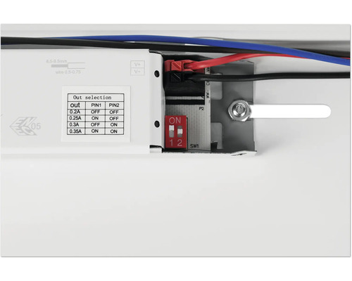 Gros plan d''un appareil électronique avec des commutateurs et des raccords de câbles pour le réglage de la puissance de sortie.