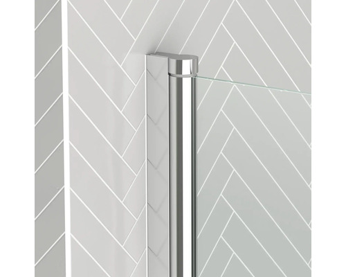 Detail einer Duschkabine mit Chromprofil und Glaswand vor einer Wand mit Fischgrätenmuster