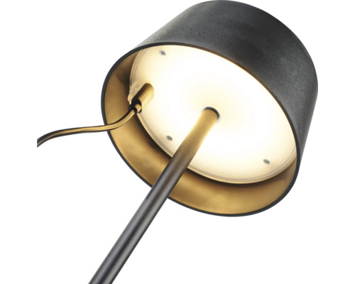 Gros plan d''une lampe de bureau avec une base ronde et un abat-jour.