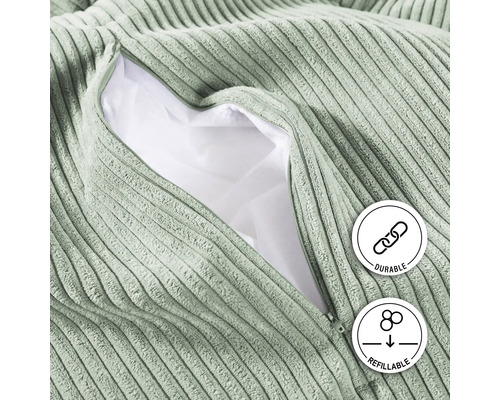 "Gros plan d''un pouf en velours côtelé avec une fermeture éclair ouverte, montrant le rembourrage 