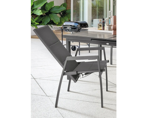 Gartenszene mit verstellbarem Relaxsessel, Grill und Gartentisch