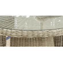 Detailansicht eines Gartentisches mit Glasplatte und Rattanstruktur