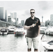 Mann mit Inbusschlüsselsatz vor einem Hafen