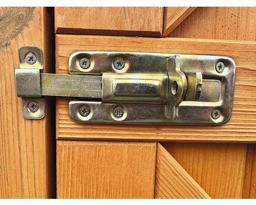 Verrou en métal fixé sur une porte en bois