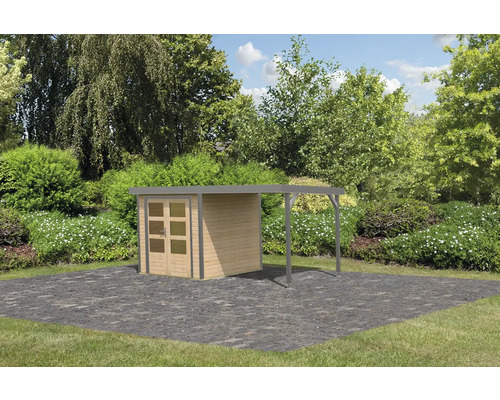Abri de jardin avec carport sur pavés dans le jardin