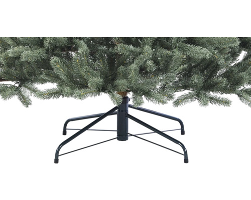 Gros plan d''un arbre de Noël artificiel avec un pied en métal