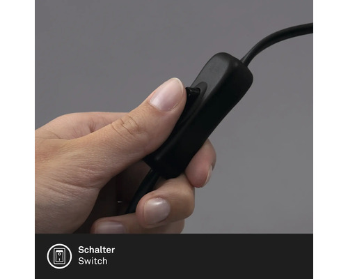 Une main actionne l''interrupteur d''une lampe.