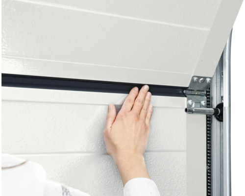 Detailansicht eines Garagentors mit Dichtung und Hand