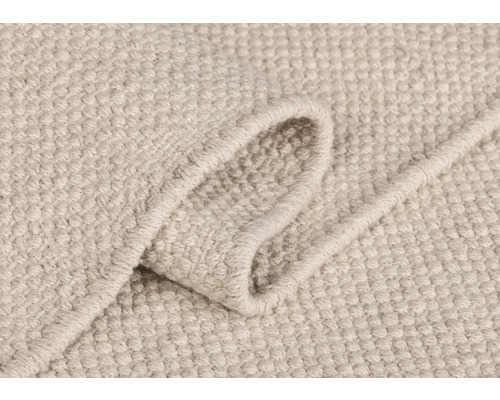 Vue détaillée d''un tapis de couleur claire avec une texture tissée