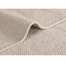 Gros plan d''un tapis beige à la texture tissée